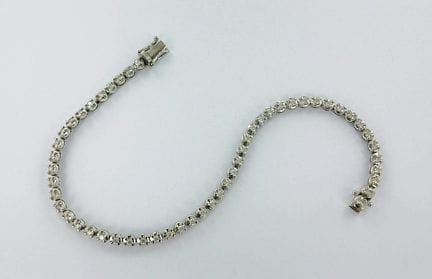 Bracelet or gris 750 millièmes serti d'une ligne d