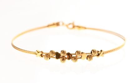 PULSERA RÍGIDA flexible de oro de 750‰ con motivos