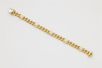 An 18k yellow gold curb chain bracelet with brilli