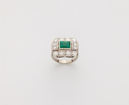 An 18k white gold diamond and fine emerald ring.

