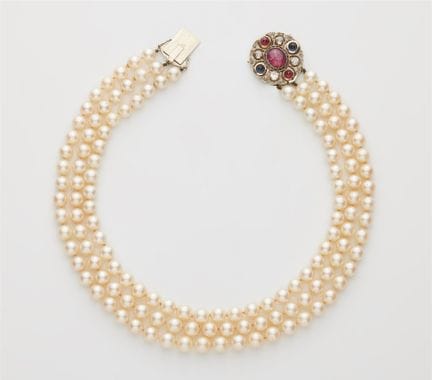 A three-strand cultured pearl necklace with a diam