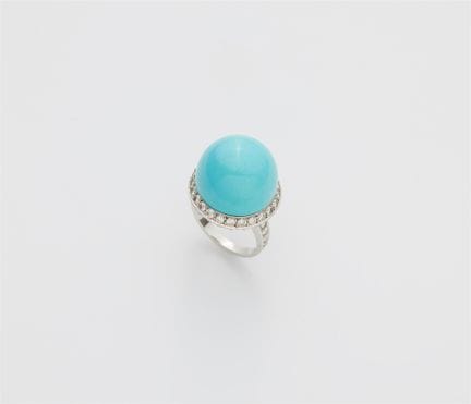 An 18k white gold diamond and turquoise sphere rin