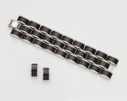 An 18k white gold ebony and diamond demi-parure.

