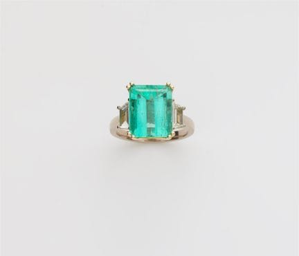 An 18k gold diamond and Colombian emerald three st