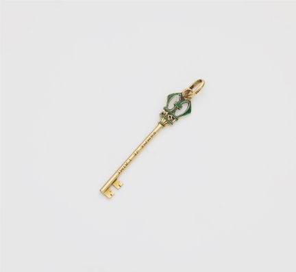 A small French 18k gold and enamel key charm as to