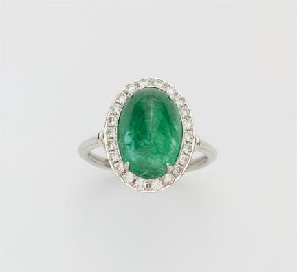 An 18k white gold diamond and sugarloaf-cut emeral