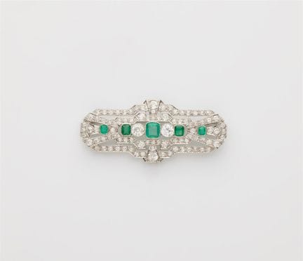 A 14k white gold diamond and emerald Art Déco broo