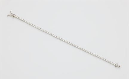 An 18k white gold and brilliant-cut diamond rivièr