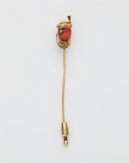 An 18k gold black enamel diamond and carved Medite