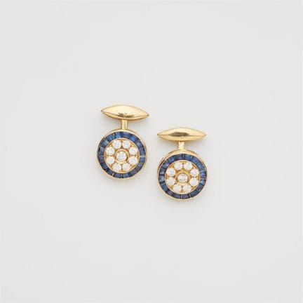 A pair of 18k yellow gold diamond and sapphire cuf