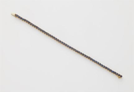 An 18k white gold and sapphire rivière bracelet.

