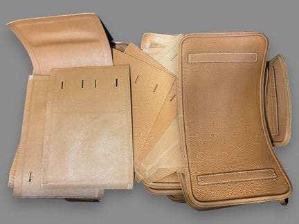 [LEATHER HANDLE]
Box containing scraps of brown gr