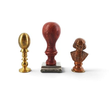 Set of three wooden and metal stamps, one of which