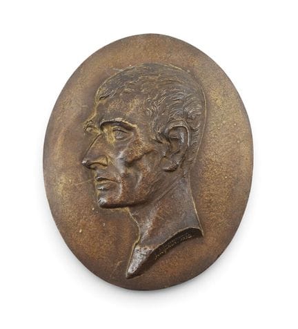 Bronze medallion depicting a man's bust in bas-rel
