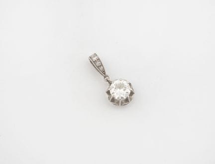 Platinum (850) pendant set with a claw-set half-cu