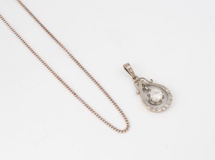 A white gold (750) pendant in the shape of an open