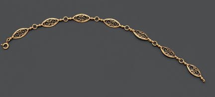 Bracciale articolato in oro giallo 750, con maglie