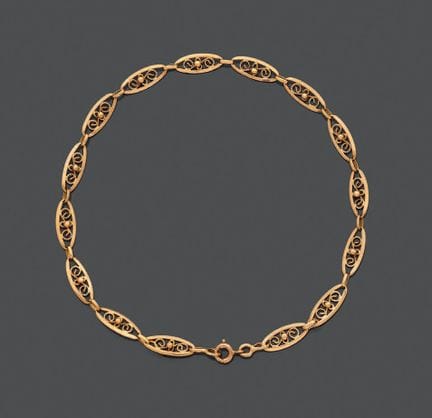 Bracciale articolato in oro giallo 750, con maglie