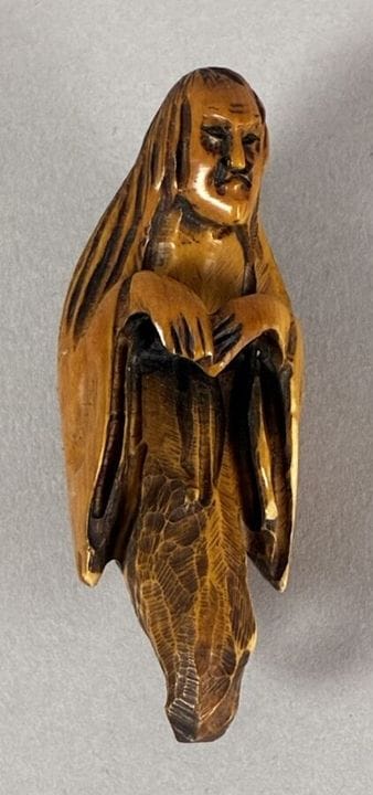 Wooden netsuke depicting an elderly man. Meiji per
