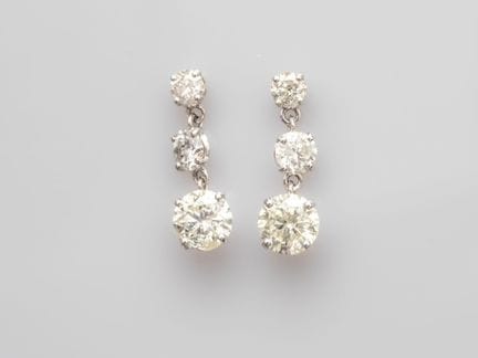 Pair of 750°/°° (18K) white gold earrings, set wit
