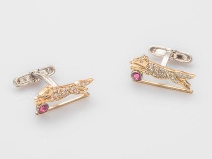 Pair of two-tone gold cufflinks featuring stylized