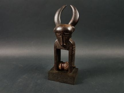 吉米尼（Djimini）滑轮，科特迪瓦
木质
马镫顶部饰有双面神面孔，其中一面长着一对牛角。
高 2