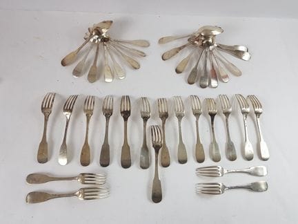 Assortment of mismatched silver cutlery in the "Un
