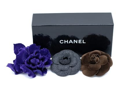 *CHANEL 
Set of three fabric camellia brooches: on