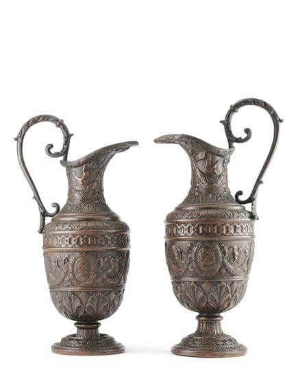 Two embossed and engraved copper pitchers, bodies 