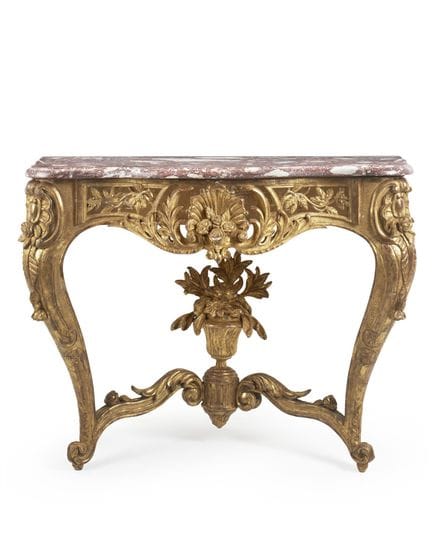 A carved and gilded wood console table, the pierce
