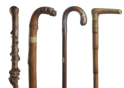 Four carved wood walking sticks, including one wit