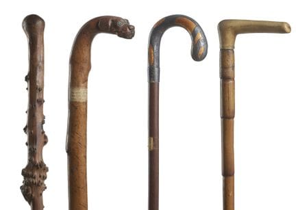 Four carved wood walking sticks, including one wit