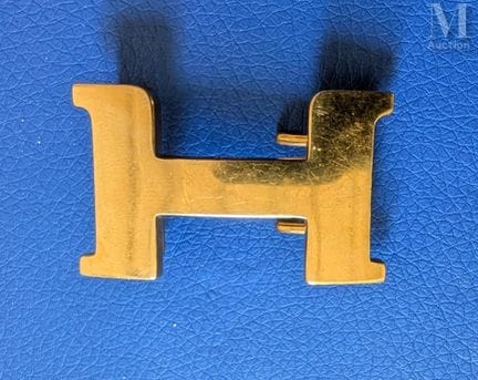 HERMES
Two "H" belt buckles, known as "Constance,"