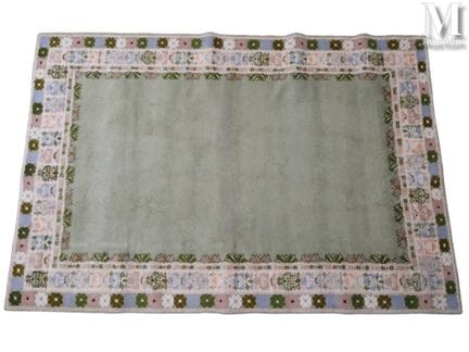 ORIENT
Light green wool rug framed by floral borde