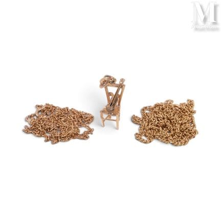 Two gold chains and a charm
Two gold chains and a 
