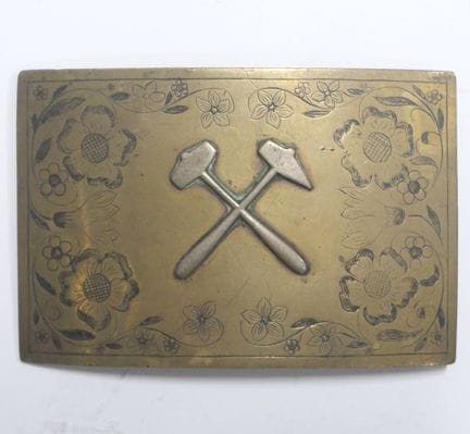 Corporate belt buckle.
Chiseled brass plate with a