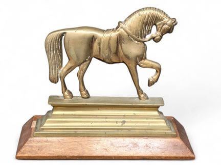 Bronze sculpture of a horse in profile on a tiered