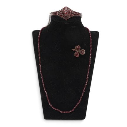 Various pieces of garnet jewelry, including a bang