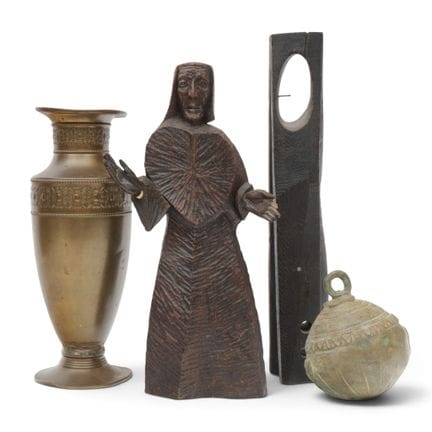 Two wooden sculptures, an Indian bell, and a coppe