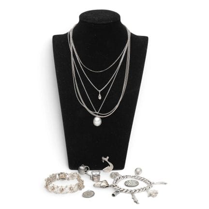 Various pieces of jewelry, including a silver char