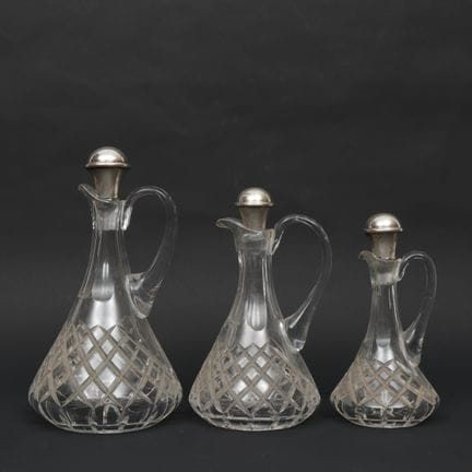 Three cut crystal decanters, circa 1900, with silv
