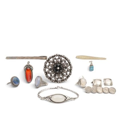 Various pieces of silver jewelry, including a brac