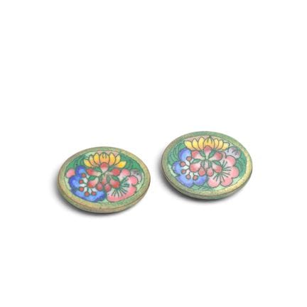 A pair of enameled copper cufflinks with a floral 
