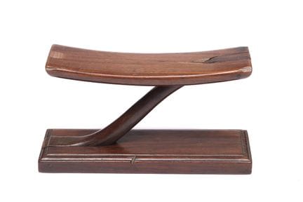 China, a wooden neck rest, L. 26 cm. Provenance: A
