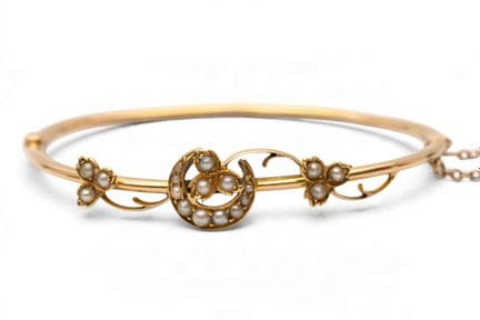 A 19th-century pearl bangle. The top features a de