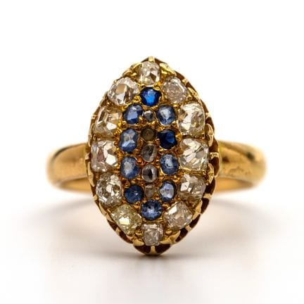 A sapphire and diamond ring. The top is marquise-s