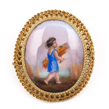 A romantic enameled brooch depicting a harvest sce