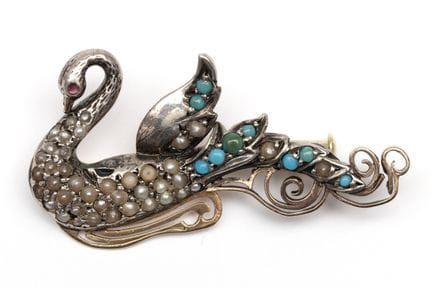 A pearl- and gem-set swan brooch, gliding on waves