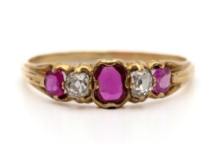 A five-stone ruby and diamond ring set with three 