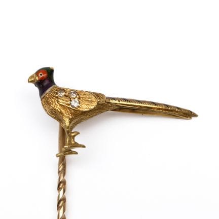 A pheasant stickpin. The pheasant has an enameled 